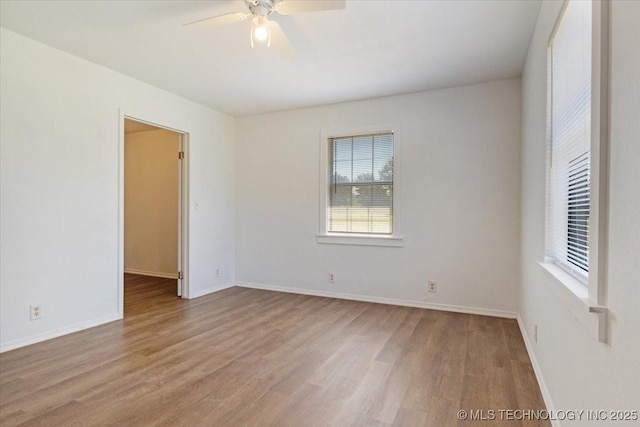 unfurnished room featuring ceiling fan, baseboards, and wood finished floors