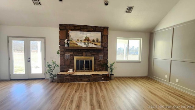 living room with a healthy amount of sunlight, visible vents, and a fireplace