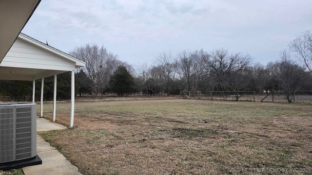 view of yard with fence and central air condition unit