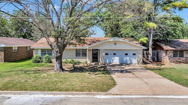 ranch-style home with a garage, a front yard, brick siding, and driveway