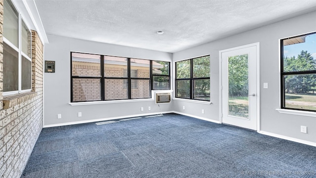 413 NW 15 NW, Ardmore, OK 73401 - unfurnished room featuring dark colored carpet, baseboards, and a textured ceiling