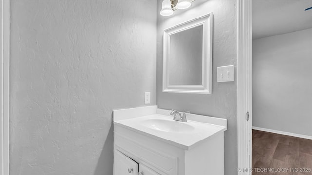 413 NW 15 NW, Ardmore, OK 73401 - bathroom featuring wood finished floors and vanity