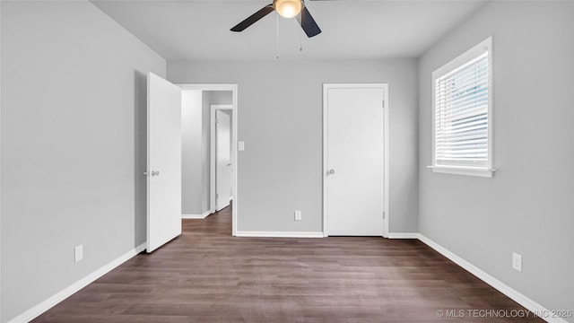 unfurnished bedroom featuring ceiling fan, wood finished floors, and baseboards