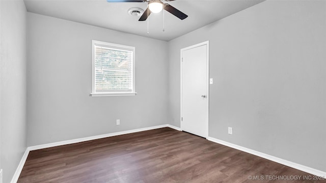 empty room featuring visible vents, ceiling fan, baseboards, and wood finished floors