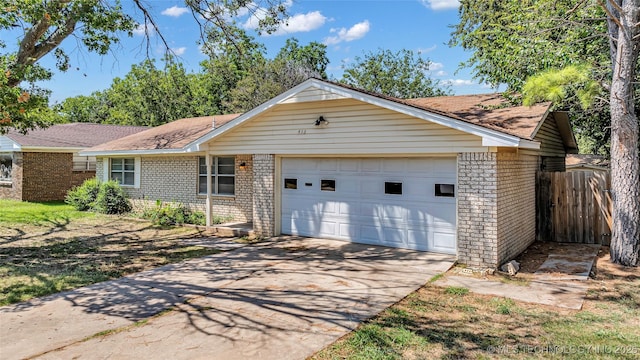 single story home featuring a garage, brick siding, driveway, and fence