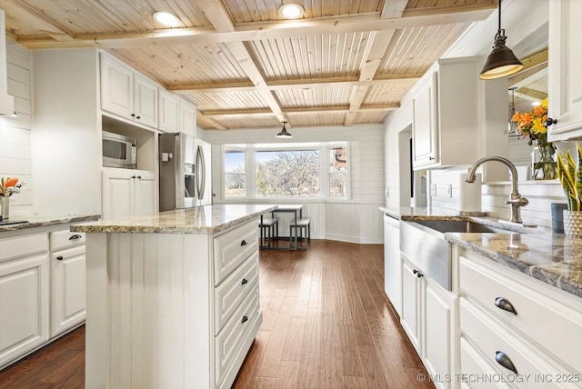 kitchen with dark wood-style floors, stainless steel appliances, and white cabinetry