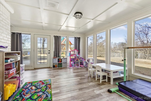 sunroom featuring coffered ceiling and a healthy amount of sunlight