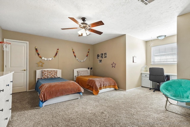 bedroom featuring light colored carpet, visible vents, ceiling fan, a textured ceiling, and baseboards