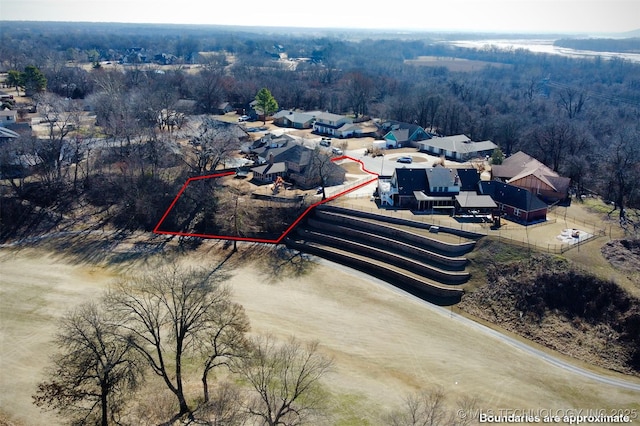 birds eye view of property featuring a view of trees