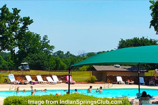 community pool featuring a patio area and fence