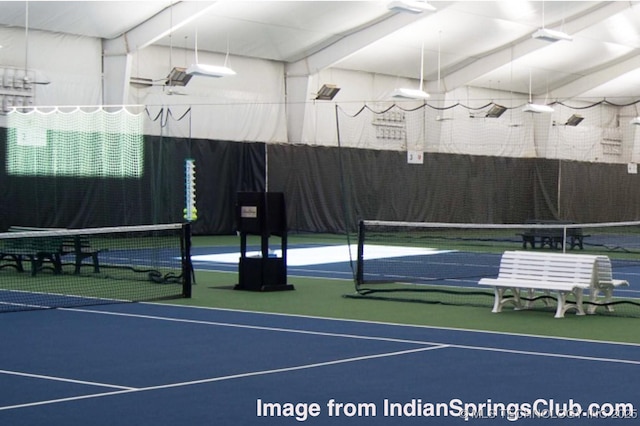 view of sport court featuring fence