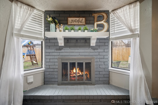 interior details with a brick fireplace and a textured ceiling