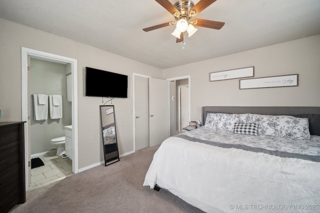 bedroom with baseboards, a ceiling fan, ensuite bathroom, a textured ceiling, and carpet flooring