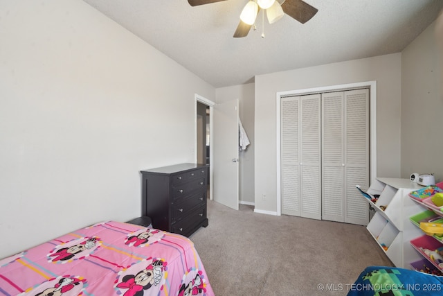 carpeted bedroom featuring ceiling fan, a closet, a textured ceiling, and baseboards