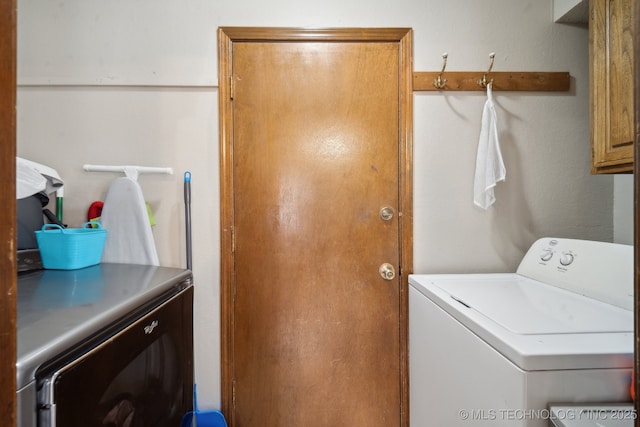 clothes washing area with cabinet space and washing machine and dryer