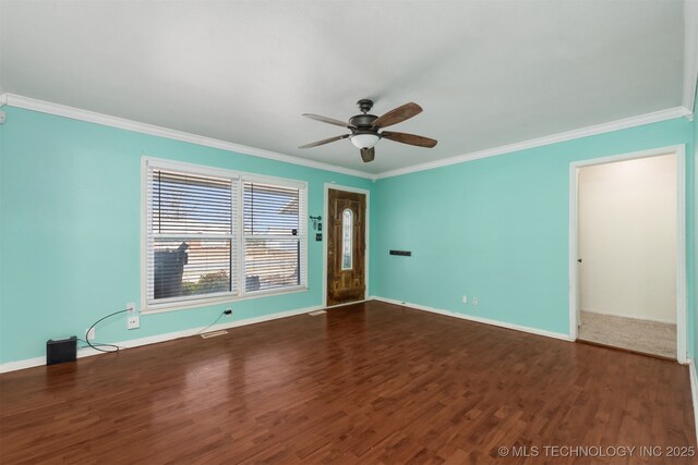 unfurnished room with ceiling fan, baseboards, wood finished floors, and crown molding