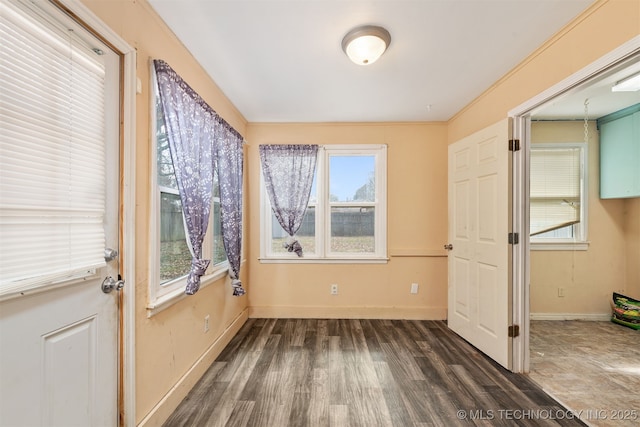 unfurnished bedroom featuring baseboards and wood finished floors