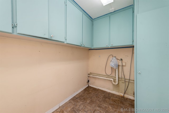 washroom featuring cabinet space and baseboards