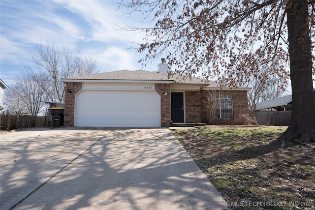 single story home with a garage, brick siding, and fence