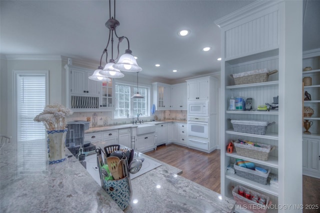 kitchen featuring ornamental molding, open shelves, white appliances, and light stone countertops
