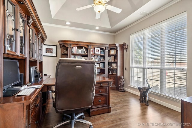 office area with ceiling fan, ornamental molding, a raised ceiling, and wood finished floors