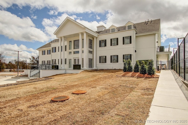 view of front of home with fence and stucco siding