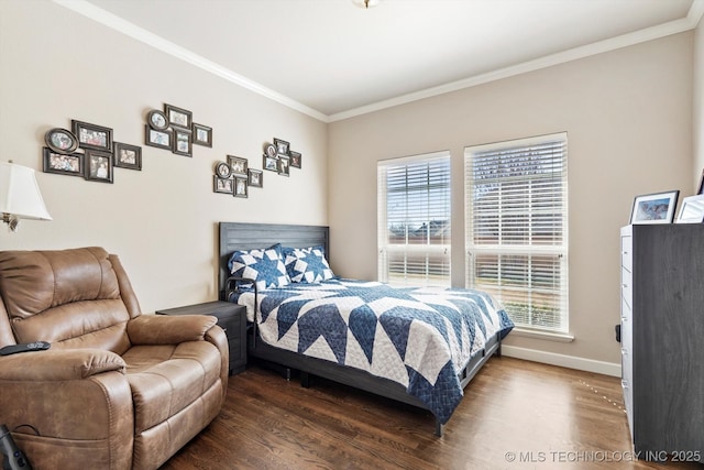 bedroom featuring baseboards, crown molding, and wood finished floors