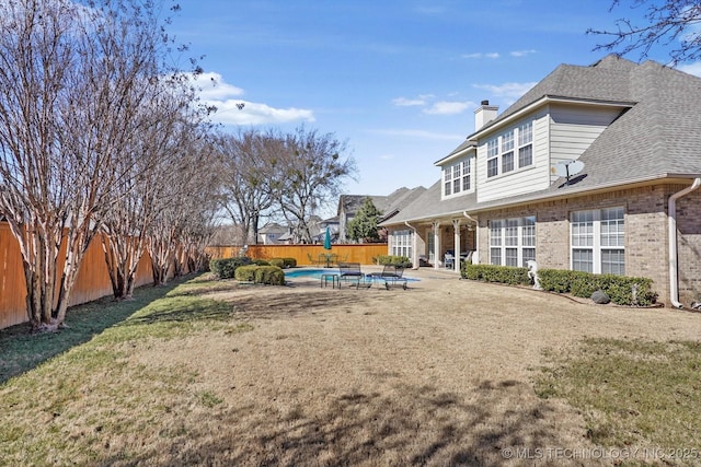 view of yard featuring a patio, a fenced backyard, and a fenced in pool