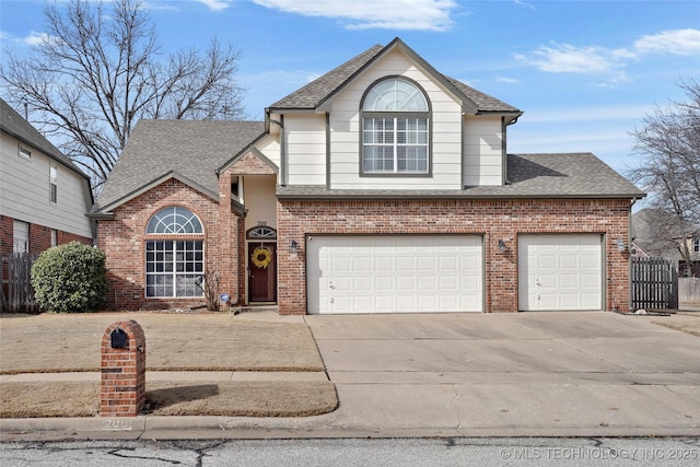 view of front of house featuring roof with shingles, brick siding, an attached garage, fence, and driveway