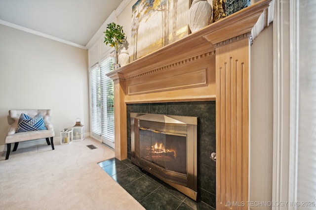 details featuring a fireplace with flush hearth, visible vents, baseboards, carpet, and crown molding