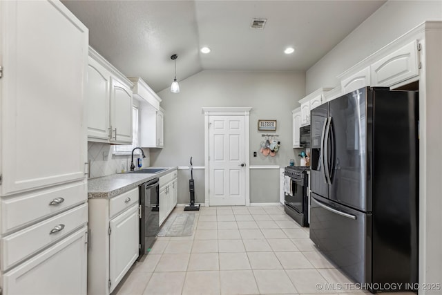 kitchen with light tile patterned floors, light countertops, white cabinets, a sink, and black appliances