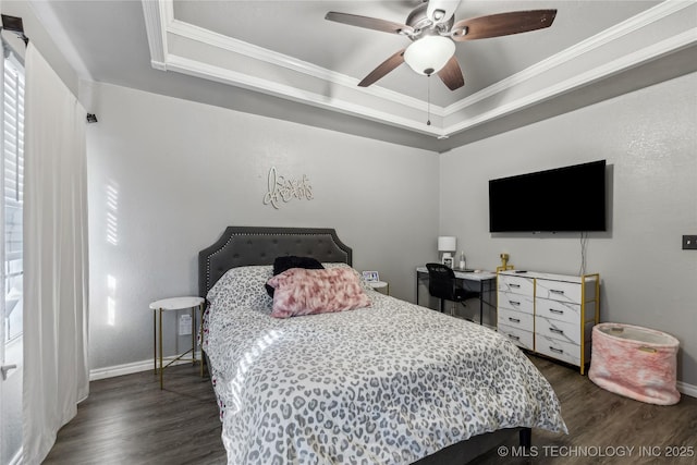 bedroom featuring a tray ceiling, dark wood finished floors, crown molding, a ceiling fan, and baseboards