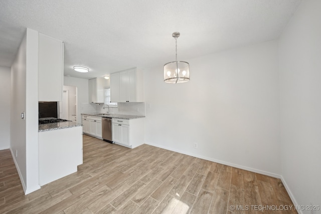 kitchen featuring a sink, white cabinetry, light wood-type flooring, light stone countertops, and dishwasher