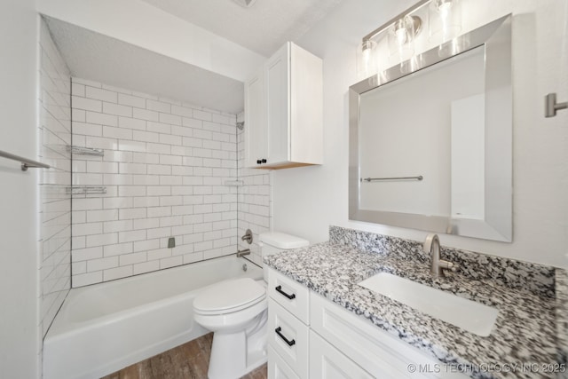 full bathroom featuring vanity,  shower combination, wood finished floors, and toilet