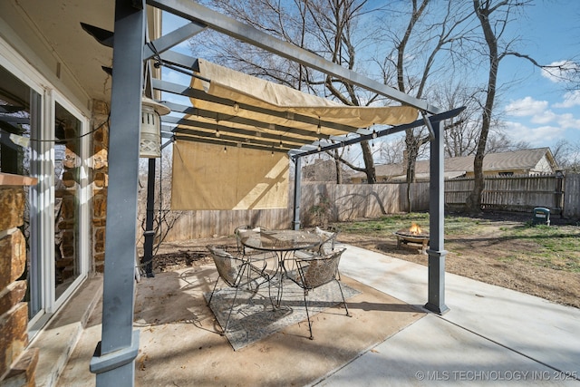 view of patio featuring outdoor dining space, fence, a fire pit, and a pergola