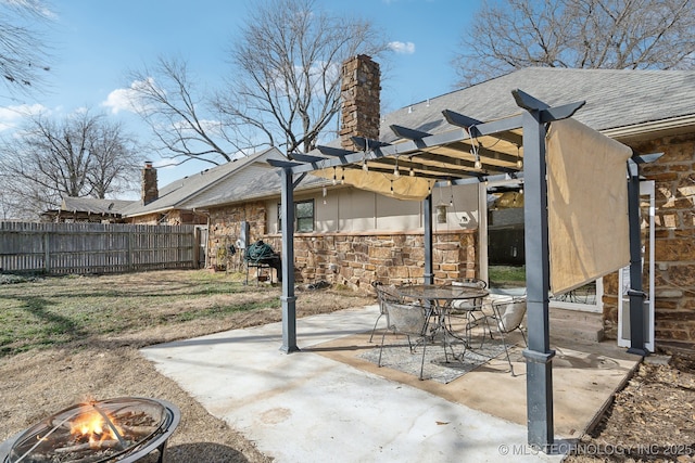 view of patio with fence, a fire pit, outdoor dining area, and a pergola