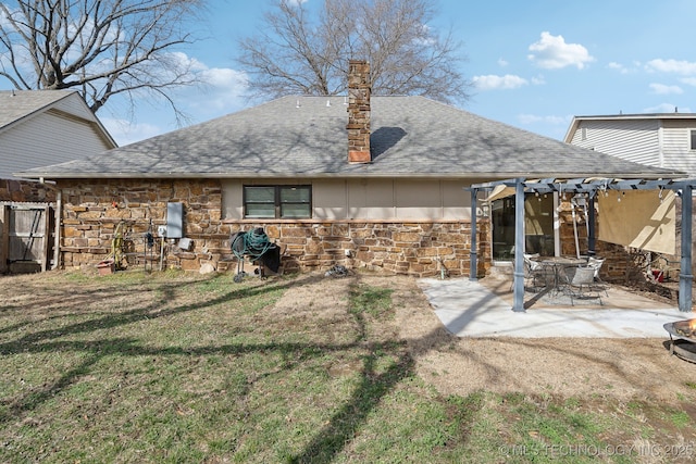 rear view of property with roof with shingles, a lawn, a patio area, a pergola, and stone siding