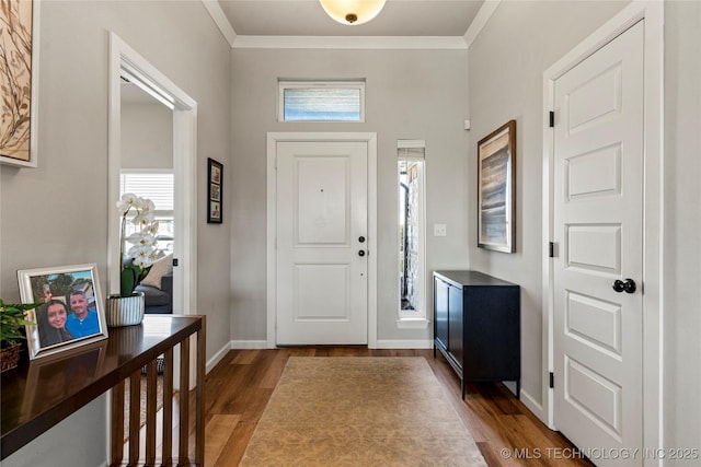 entrance foyer with a healthy amount of sunlight, crown molding, and wood finished floors