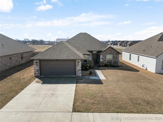 view of front of house featuring roof with shingles, a garage, stone siding, driveway, and a front lawn