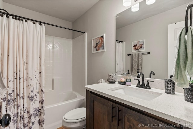 bathroom with shower / bath combo with shower curtain, vanity, and toilet