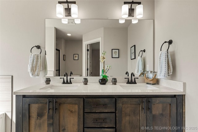 full bathroom featuring double vanity and a sink