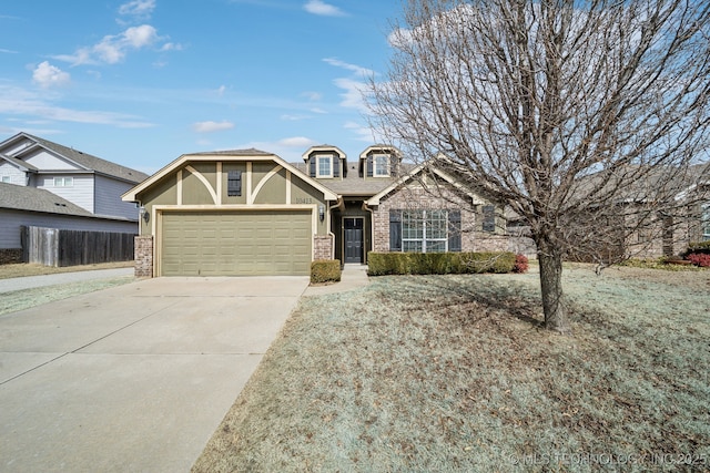 craftsman-style house featuring a garage, concrete driveway, brick siding, and fence