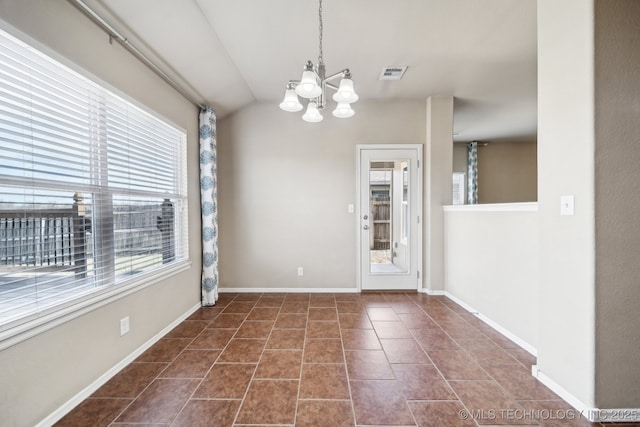 unfurnished dining area with a chandelier, dark tile patterned floors, visible vents, and baseboards