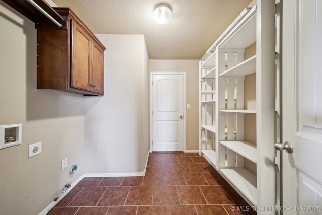 laundry room featuring a textured ceiling, washer hookup, baseboards, and hookup for an electric dryer