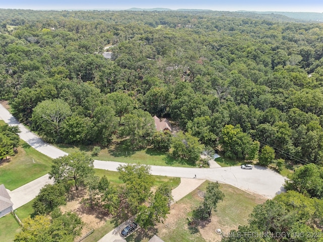 bird's eye view featuring a wooded view