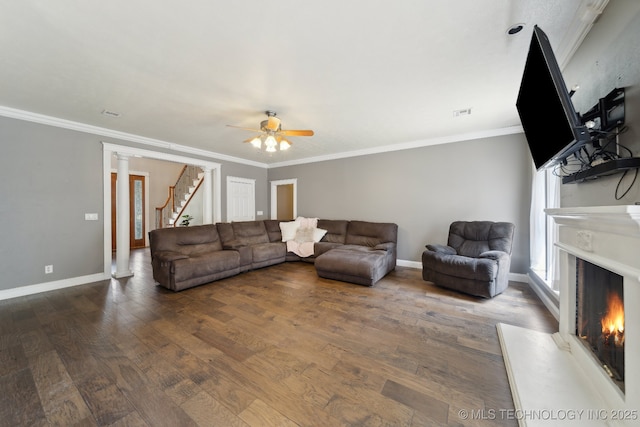 living room with baseboards, a fireplace, stairway, and wood finished floors