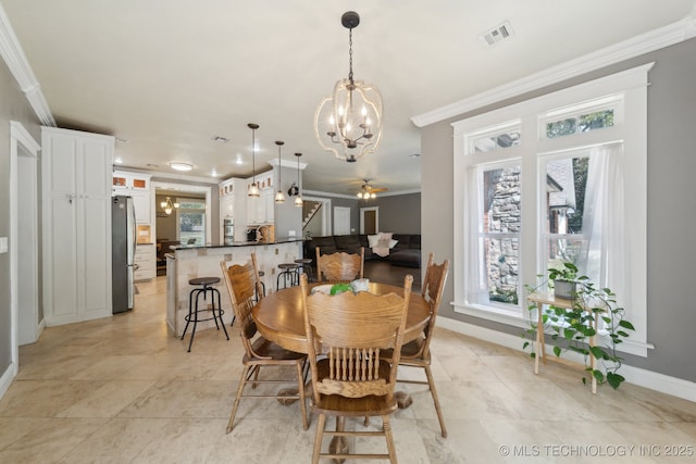 dining area featuring a wealth of natural light, visible vents, and crown molding