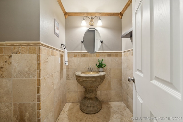 bathroom featuring ornamental molding, a wainscoted wall, and tile walls