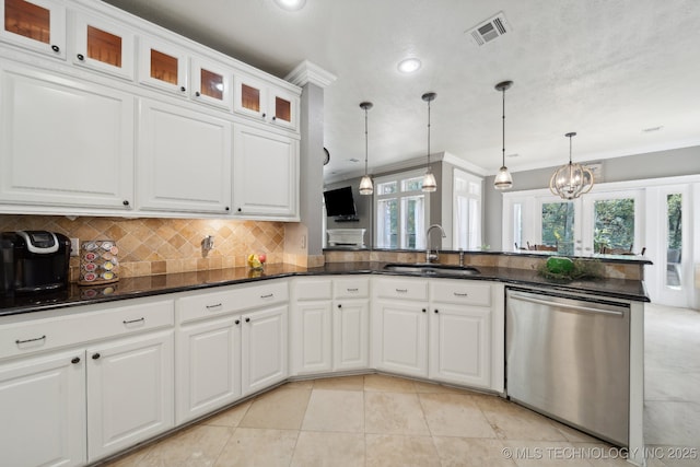 kitchen featuring a sink, visible vents, white cabinets, decorative backsplash, and dishwasher