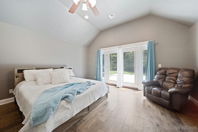 bedroom featuring ceiling fan, wood finished floors, visible vents, vaulted ceiling, and access to outside